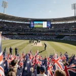 Alex Carey hits a cricket century with red and white English flags and Australian flags behind score 326/8