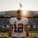 AJ McCarron standing alone in Crimson Tide jersey with Bryant‑Denny Stadium at sunset and campaign words on field