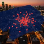 Austin skyline displays 54 homicide hotspots on map overlay with police lights at dusk