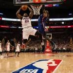 Basketball player dunking midair with holiday lights and NBA logos in a packed Christmas arena