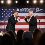 Ben Shapiro confronting Tucker Carlson on stage with American flags and dramatic lighting