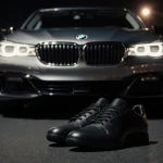 BMW 760i glows on asphalt with LED headlights and silver finish reflecting city lights