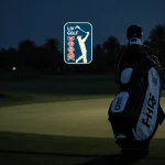 Brooks Koepka walking away from dusk golf course with faded LIV Golf logo in distance and PGA Tour logo on his bag.