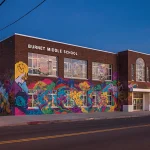 Burnet Middle School facade transforms into a vibrant charter school with colorful murals and modern design.