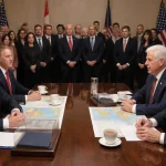 Canadian and American leaders hold a diplomatic meeting with maps and free-trade pact documents at table while observers watc