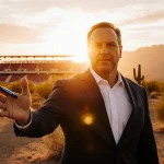 Coach Dillingham signing contract with pen in hand with desert sunset and Arizona State stadium behind