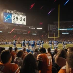 Lions players walking off Ford Field stadium with scoreboard reading 29-24 Steelers and fans slumped in the stands