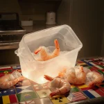 Container of frozen shrimp being seized with a glowing edge indicating radiation and surrounded by a mosaic of state flags
