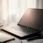 HP ZBook 8 G1i glows with warm screen light with matte-black surface with natural light from left and scattered pens.