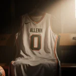 Hurricane jersey draped over bench in locker room with golden hour light and abandoned basketball nearby