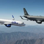 Two aircraft fly side by side with a JetBlue jet and a military tanker over Venezuela
