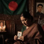 Khaleda Zia cradles a worn photograph with candles and incense and a Bangladeshi flag in a parlor of wooden carvings.