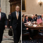 Conservative lawmakers walking away from a table with American flag while moderates debate nearby in legislative chamber