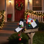 Mailbox overflowing with mail and ornaments with string lights and Christmas light from the house