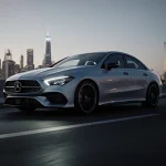 Mercedes-Benz CLA sedan parking with softly glowing LED lights and towering skyscrapers in dusk cityscape