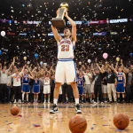Tyler Kolek raising trophy with confetti and fans in Knicks and Spurs jerseys
