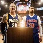 Rick Carlisle standing at podium with J.B. Bickerstaff beside him in gear amid warm lighting blurred basketball stadium