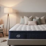 Sealy mattress rests on a minimalist bed with soothing pillows and warm lighting.