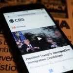 Smartphone screen pauses Trump immigration video with distorted faded effect and blurred news headlines.