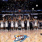 Spurs bench players erupt with joy with confetti and bright spotlights and a blurred cheering crowd.