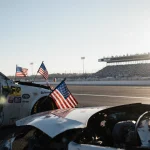 Crashed airplane wreckage displaying American flags with Greg Biffle