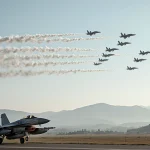 Taiwanese fighter jet takes off from runway with swarm of Chinese military aircraft overhead and misty hills in background.