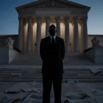 Black man Terry Pitchford standing on courthouse steps with newspapers and justice symbols while the Supreme Court looms.