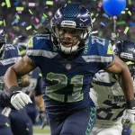 Tetairoa McMillan sprinting through Seattle defense with confetti swirling and stadium lights reflecting on helmet and champi