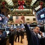 Trader celebrates a soaring stock ticker on his screen with festive holiday lights and golden glow on a bustling trading floo
