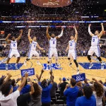 Kentucky Wildcats celebrating victory with confetti and cheering blue fans at State Farm Arena