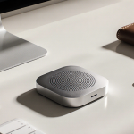 Apple AirTag 2 tracker sits on a minimalist desk with keys and phone and wallet under soft natural light