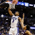 A.J. Dybantsa sinks a winning shot with score 83‑73 and confetti erupting from the crowd below over a blurred BYU court.