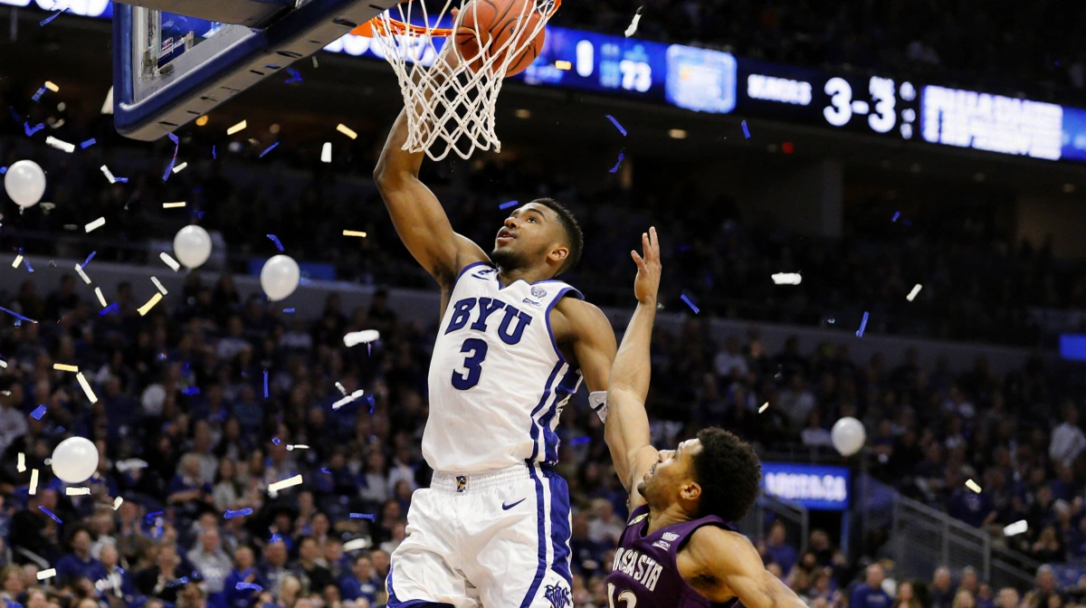 A.J. Dybantsa sinks a winning shot with score 83‑73 and confetti erupting from the crowd below over a blurred BYU court.