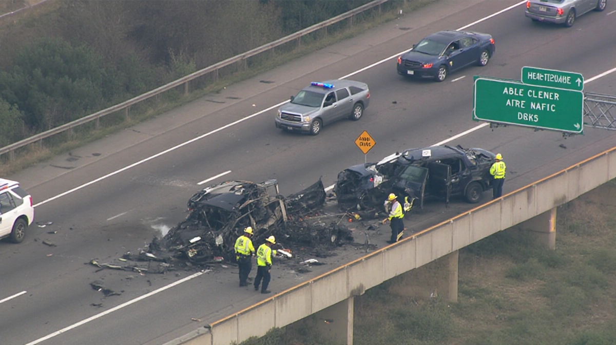 APD crews clearing wreckage with debris removal and traffic flow restored by a reopened lane marker