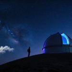 Astronomer standing on hilltop watching illuminated telescope dome with blue and purple glow against starry night sky