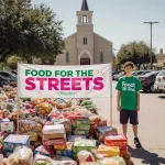 Teen volunteer stands with Food for the Streets banner and grocery donations near church building