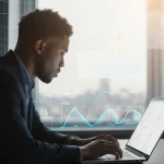 Person reviewing data on laptop with natural light and a faint Texas map grid behind, AI dashboard visible.