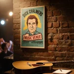 Poster hanging behind dim stage in music venue with golden glow and a guitar and coffee on table