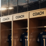 Packed football stadium shows coach names above locker doors with warm light and glass reflections hint Super Bowl matchup
