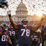 Houston Texans players celebrating playoff berth with confetti falling and fans cheering in blue and white