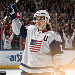 Laila Edwards holding hockey stick high in victory with U.S. women