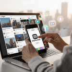 Hand reaching to tap phone screen showing Meta Verified badge with laptop open to Instagram feed and cityscape background