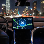 Navigation screen showing route map and robotaxi icon with blue glow and Dallas skyline reflected in windshield