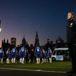 Calum McFarlane standing on Stamford Bridge pitch with King