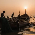 Wooden boat lying partially submerged with survivors clinging to debris and sunset orange glow behind shore