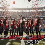 Baker Mayfield celebrates with teammates amid confetti and balloons in a bright Raymond James Stadium.