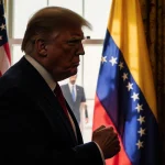 President Trump stands with clenched fist beside an American flag and a mirror reflecting Maduro being taken away