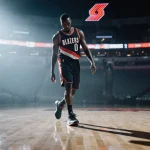 Victor Wembanyama walking on lit basketball court with knee injury reflected in wet floor and blurred Trail Blazers logo.